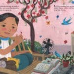 A girl sitting on the bench with a book.