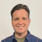 A man with brown hair and a blue shirt.